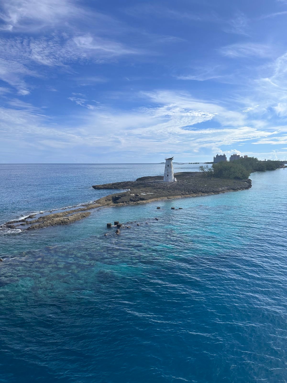 Hog Island Lighthouse and turquoise water with Atlantis Paradise Island in the distance