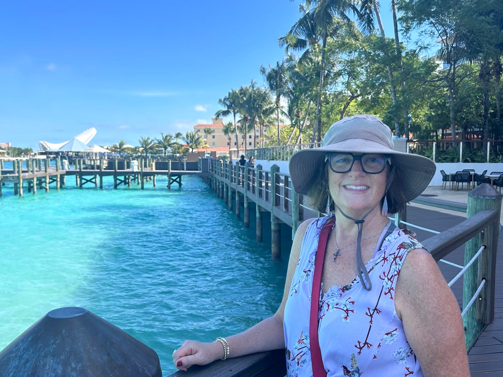 On a wooden boardwalk with turquoise Bahamian water behind