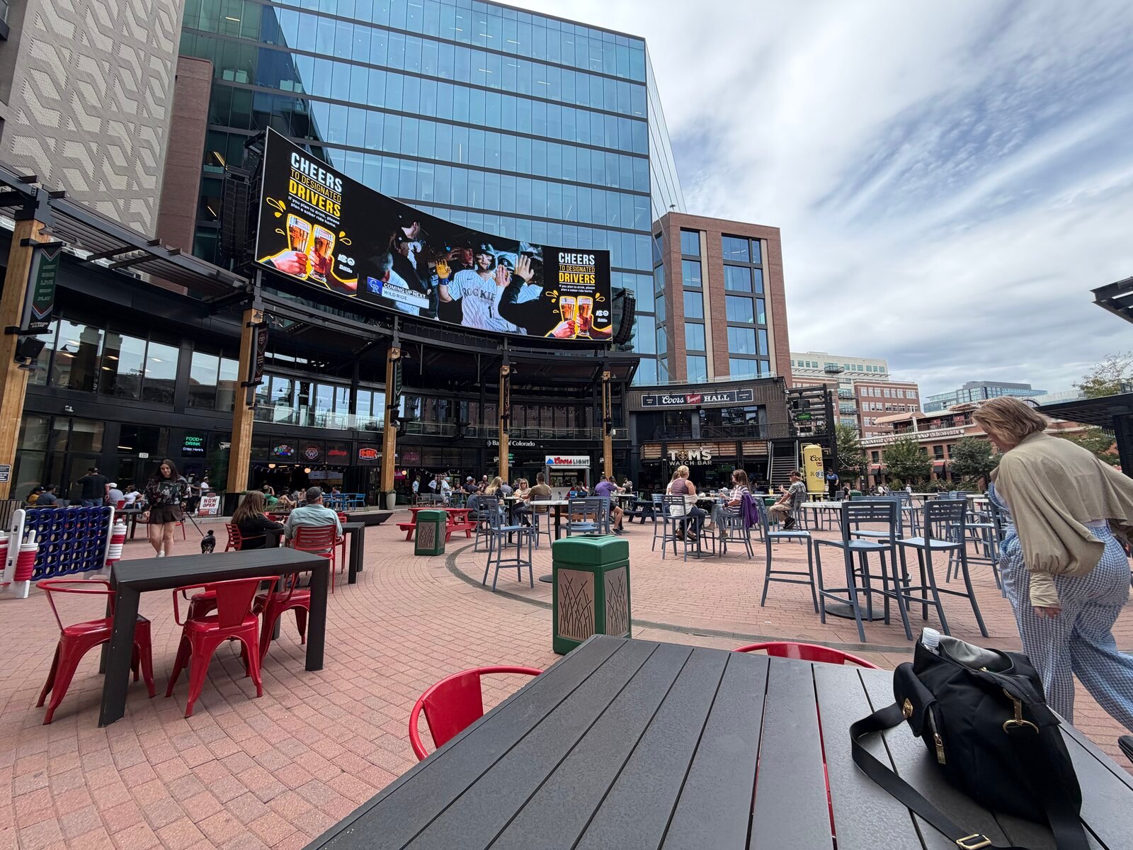 Outdoor plaza with seating and a large digital screen in Denver
