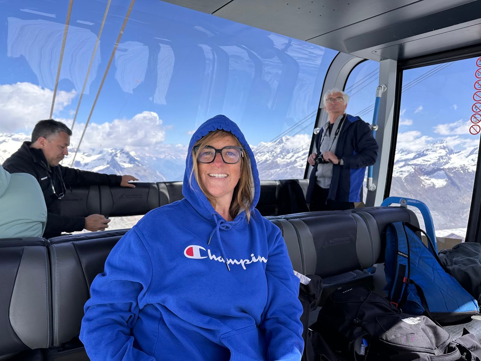 Leslie smiling inside a gondola with alpine views
