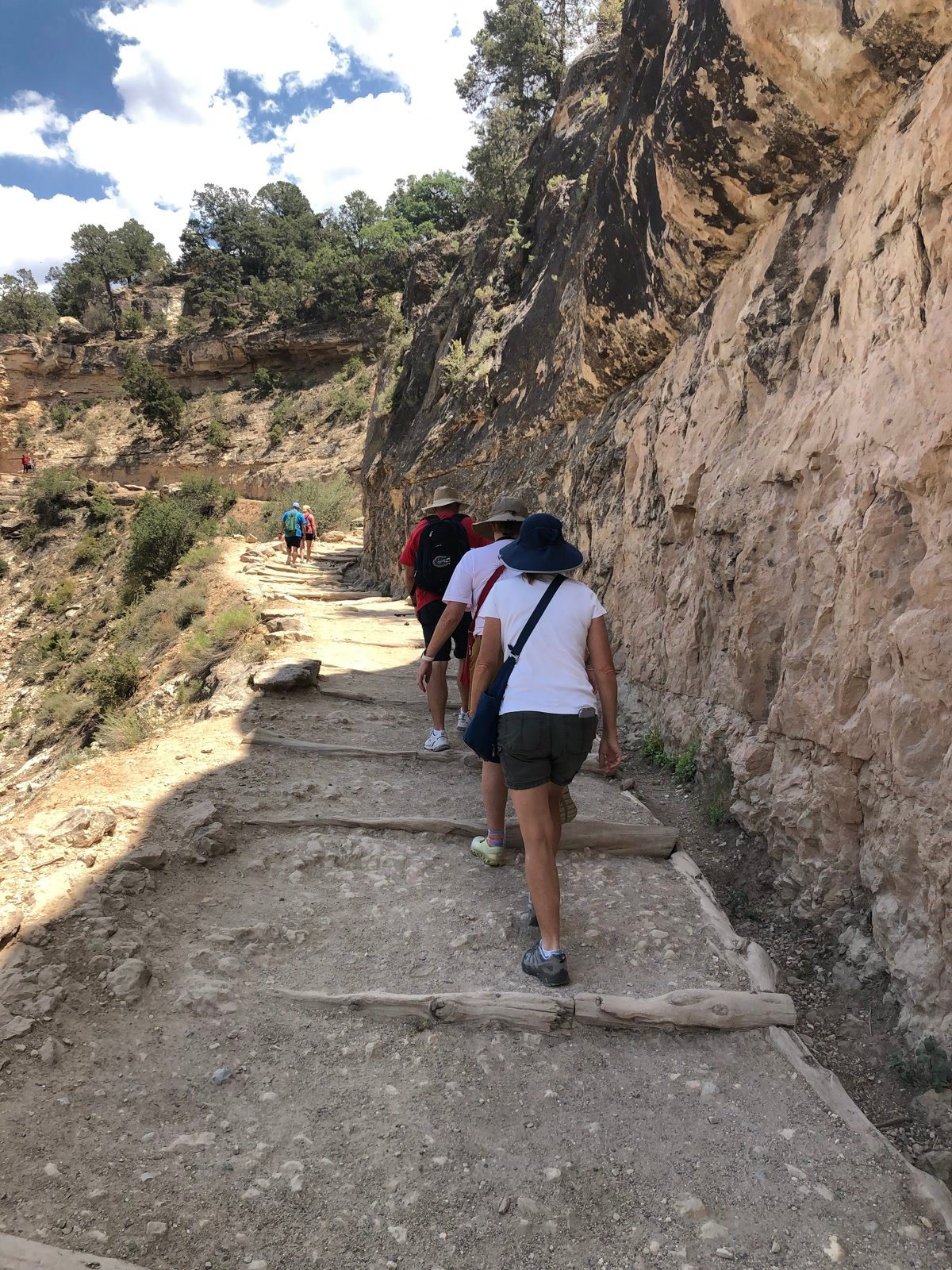 Hikers walking along Bright Angel Trail beside the canyon wall