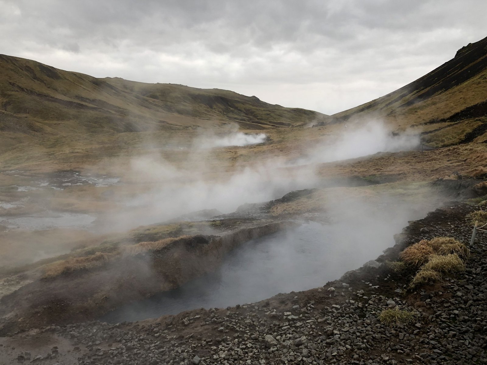 Steam rising from hot springs in an Icelandic valley