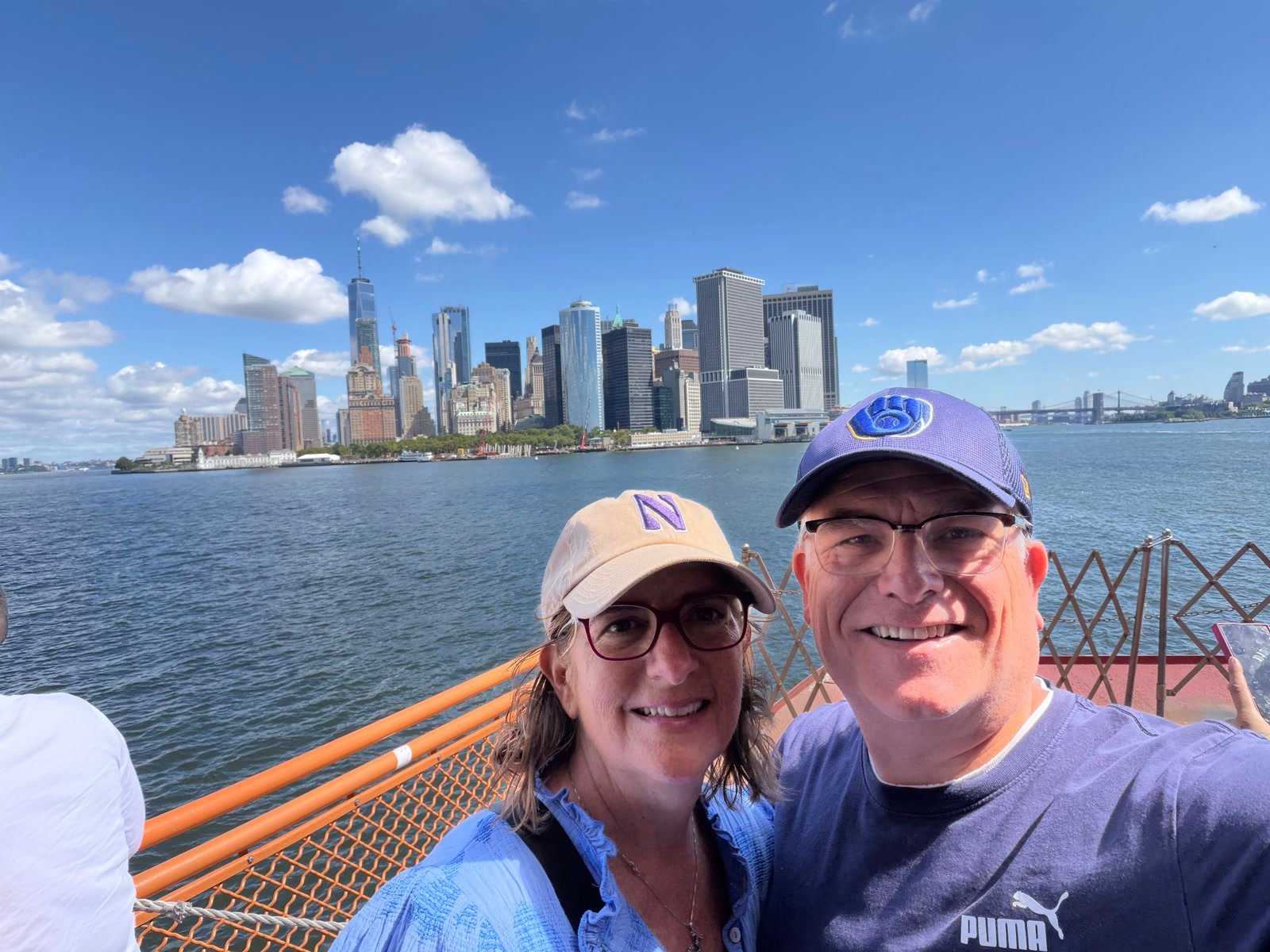 Chuck and Leslie with the Lower Manhattan skyline from the water