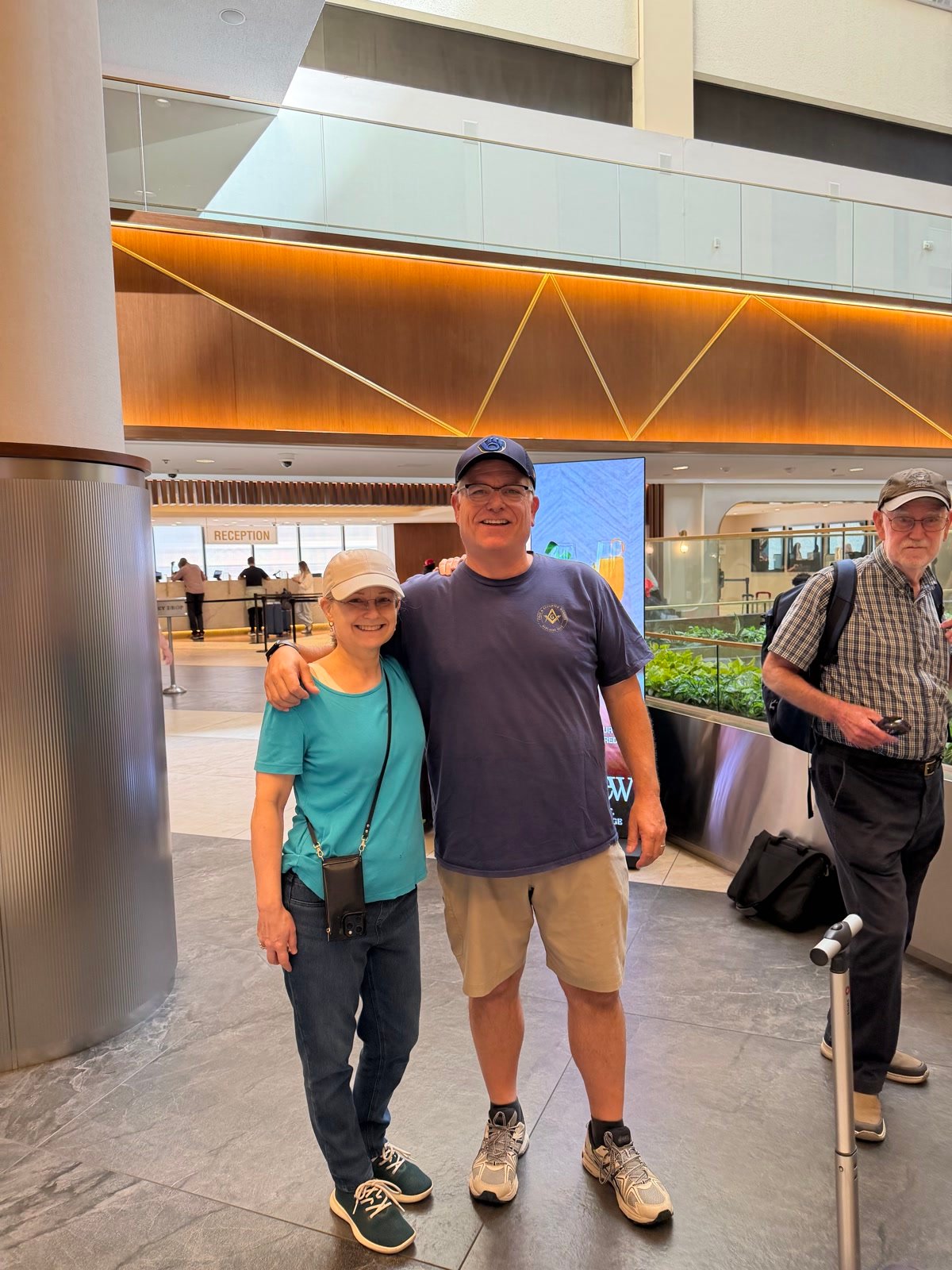 Chuck, Leslie, and Lesley Kelly in a hotel lobby